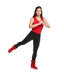 Photo of Woman in sportswear exercising with ankle weights on white background