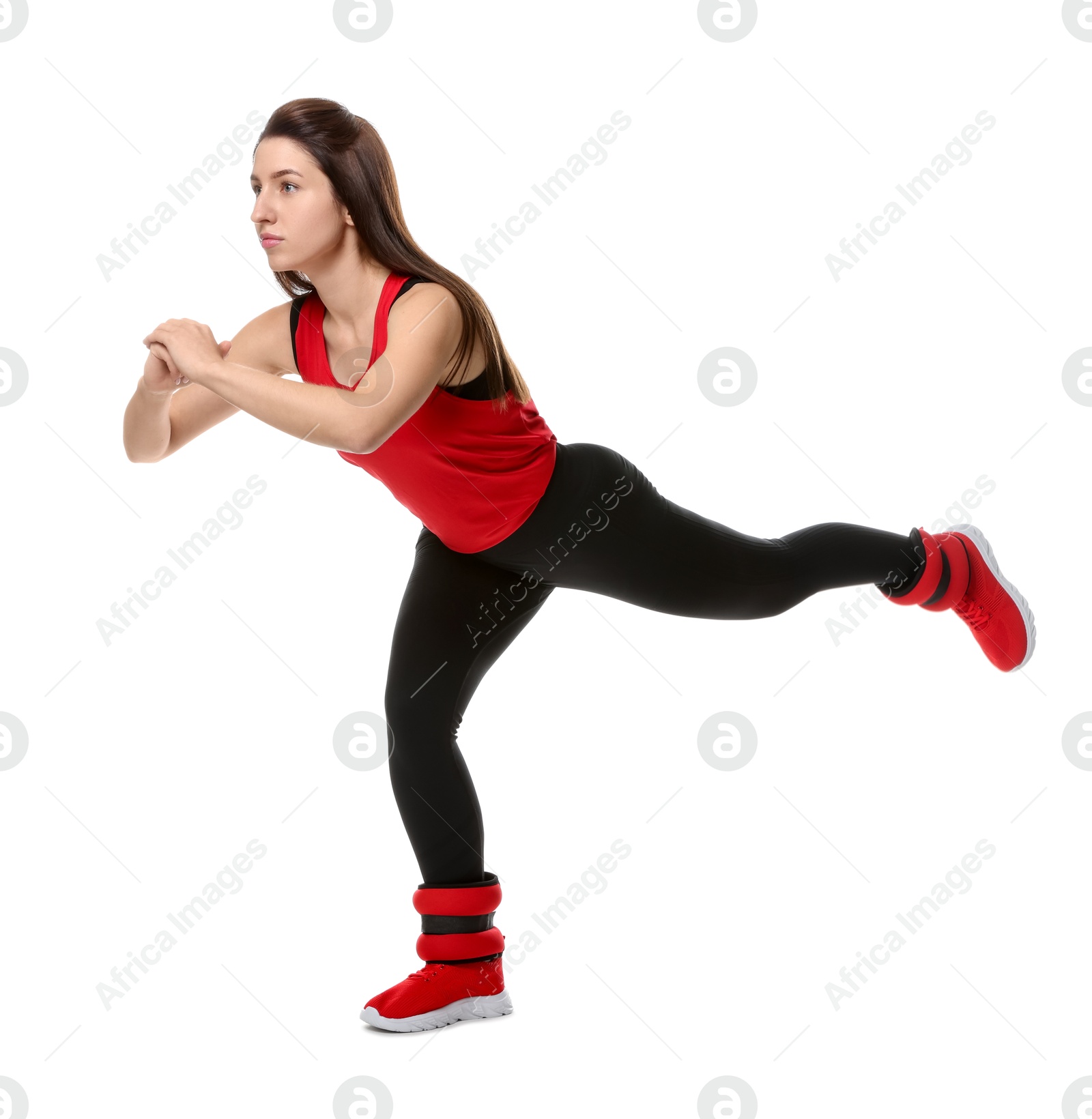 Photo of Woman in sportswear exercising with ankle weights on white background