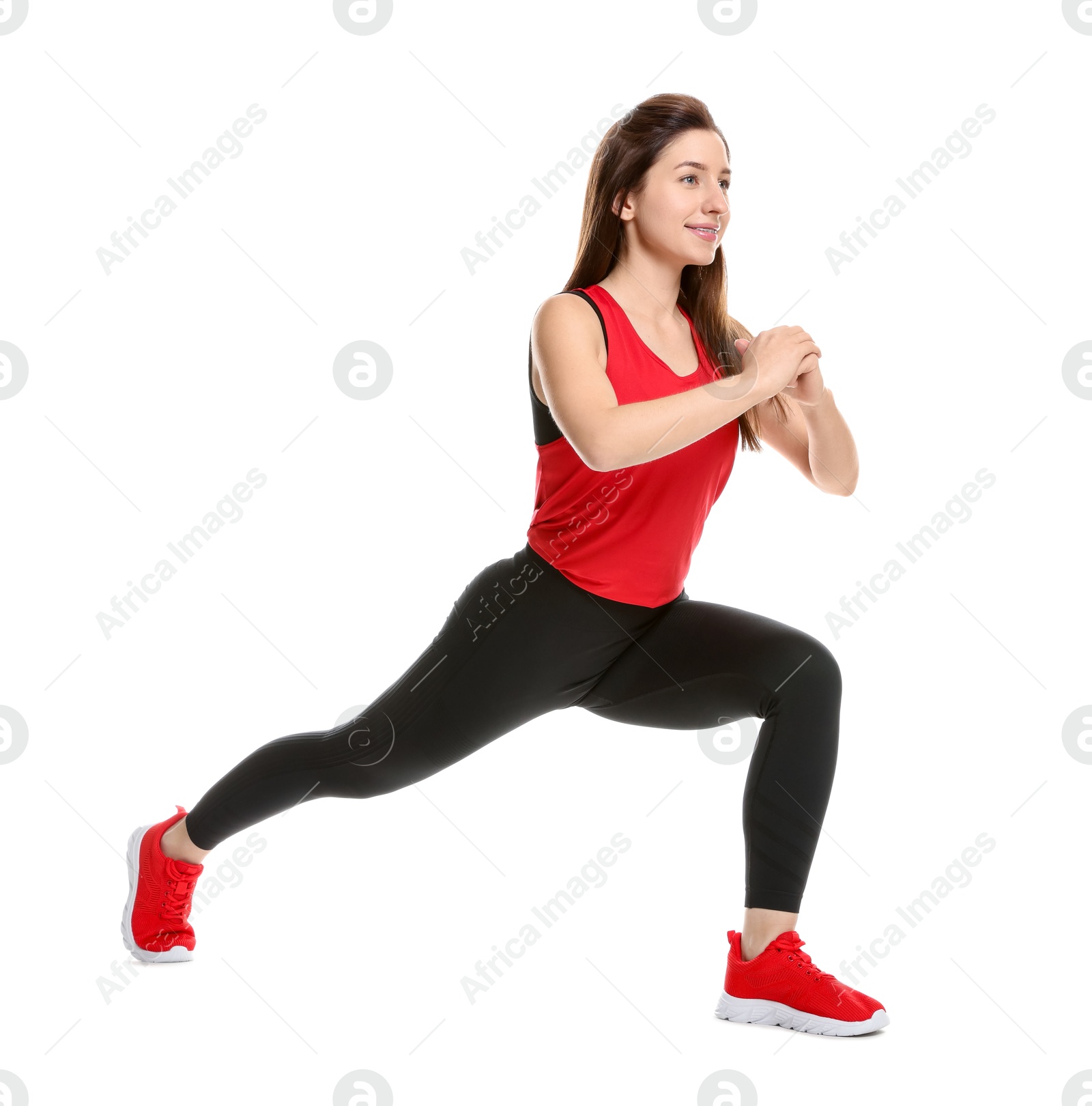 Photo of Woman in sportswear exercising on white background