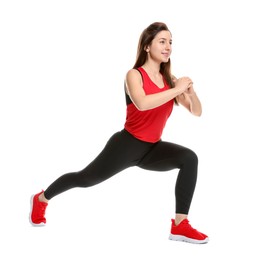 Photo of Woman in sportswear exercising on white background