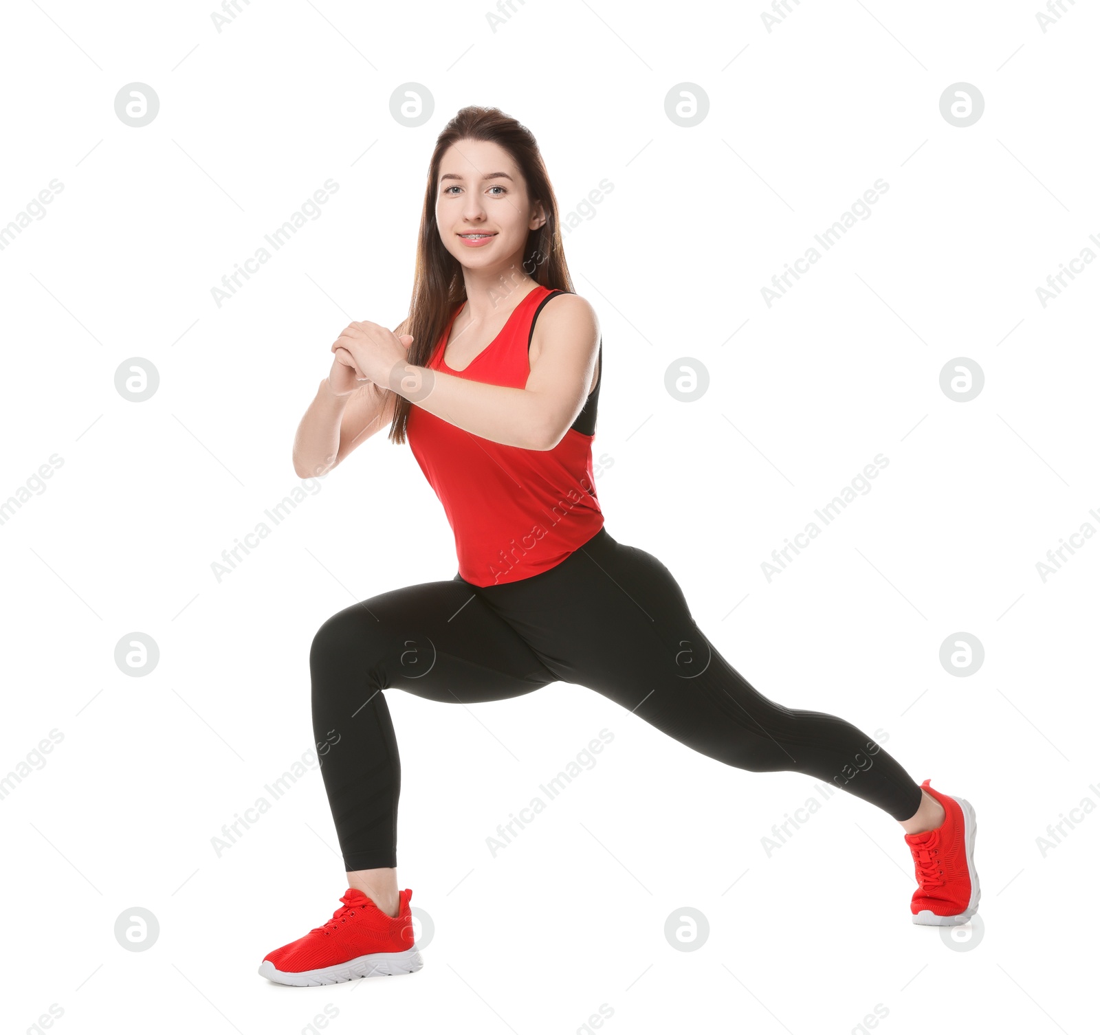 Photo of Woman in sportswear exercising on white background