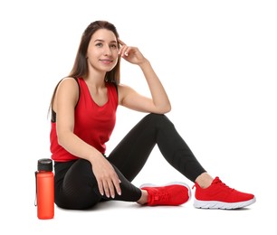 Woman in sportswear with bottle of water on white background