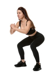 Woman in sportswear exercising on white background