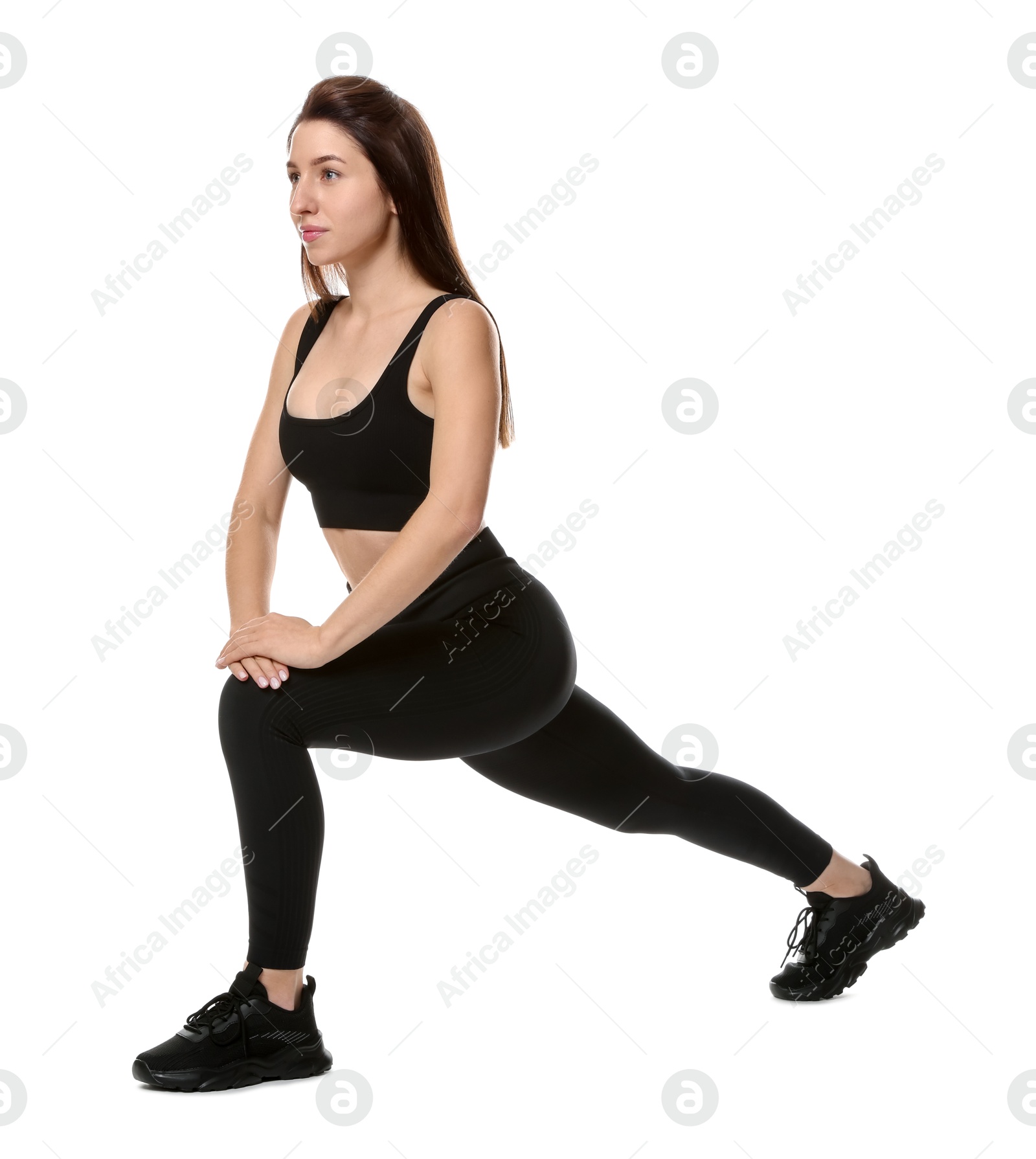 Photo of Woman in sportswear exercising on white background