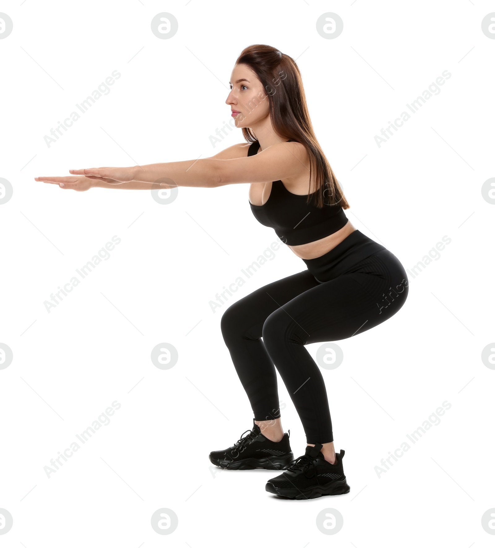 Photo of Woman in sportswear exercising on white background