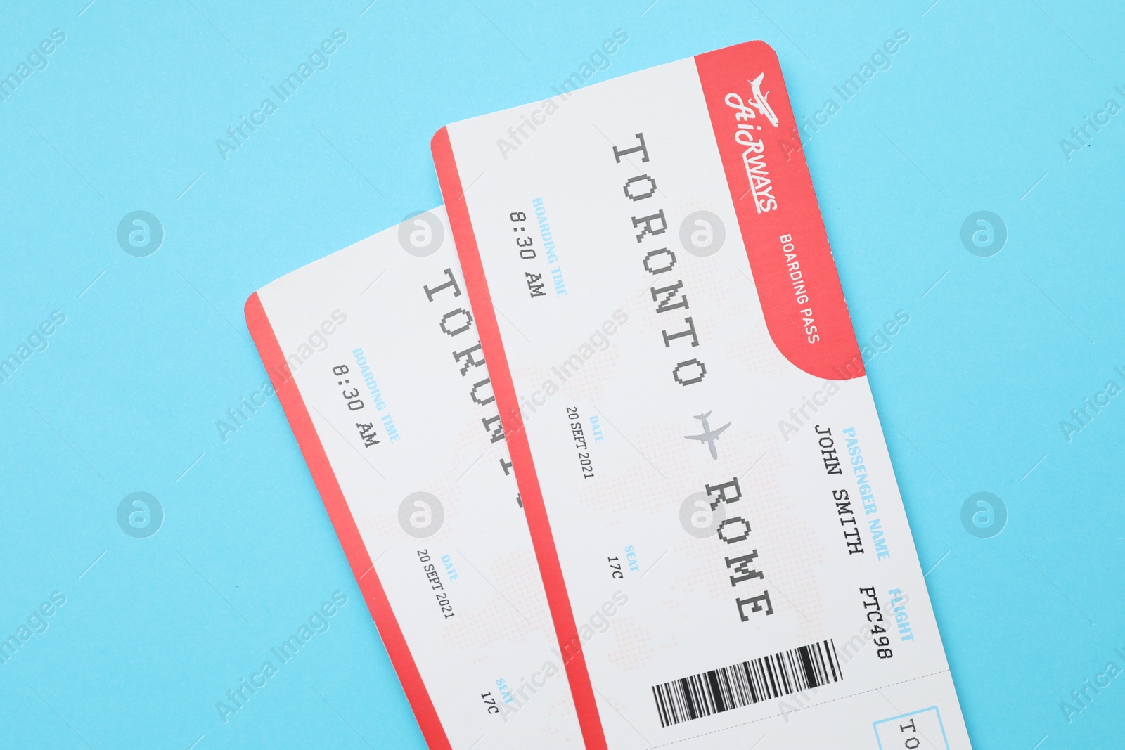 Photo of Travel agency. Flight tickets on light blue background, top view