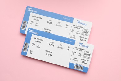 Photo of Travel agency. Flight tickets on pink background, top view