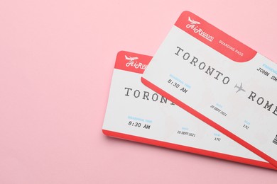 Photo of Travel agency. Flight tickets on pink background, top view. Space for text