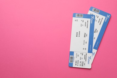 Photo of Travel agency. Flight tickets on pink background, top view. Space for text