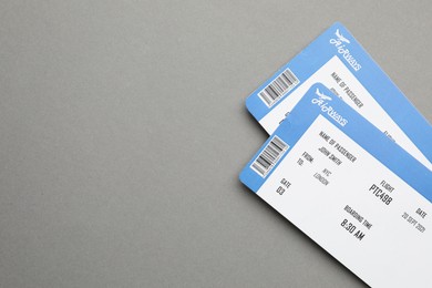 Photo of Travel agency. Flight tickets on grey background, top view. Space for text