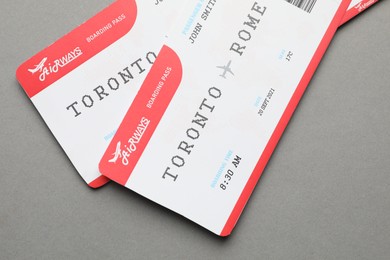 Photo of Travel agency. Flight tickets on grey background, top view