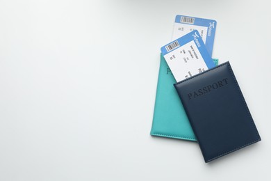 Photo of Travel agency. Flight tickets and passports on light background, top view. Space for text