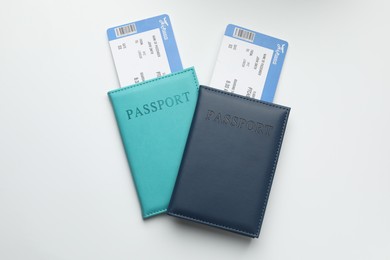 Photo of Travel agency. Flight tickets and passports on light background, top view