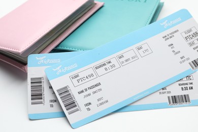 Photo of Travel agency. Flight tickets and passports on light background, closeup