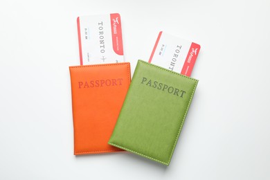 Photo of Travel agency. Flight tickets and passports on light background, top view