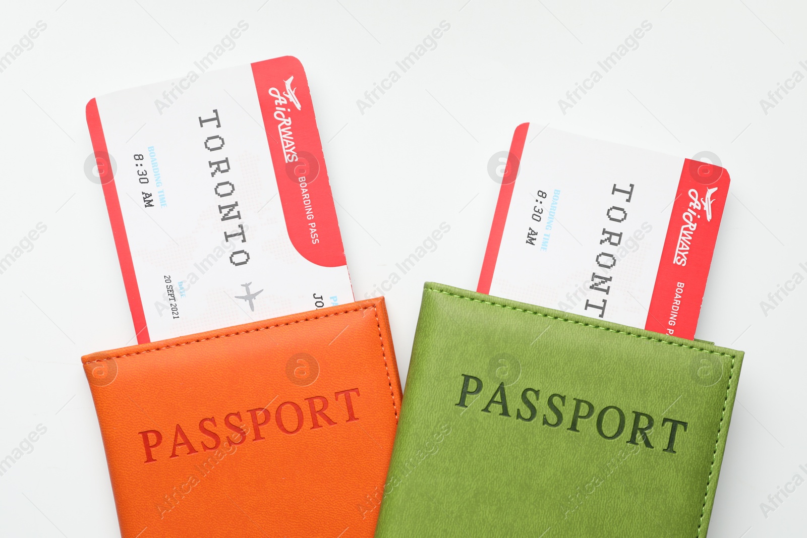 Photo of Travel agency. Flight tickets and passports on light background, top view