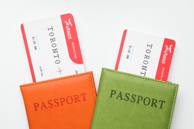 Photo of Travel agency. Flight tickets and passports on light background, top view