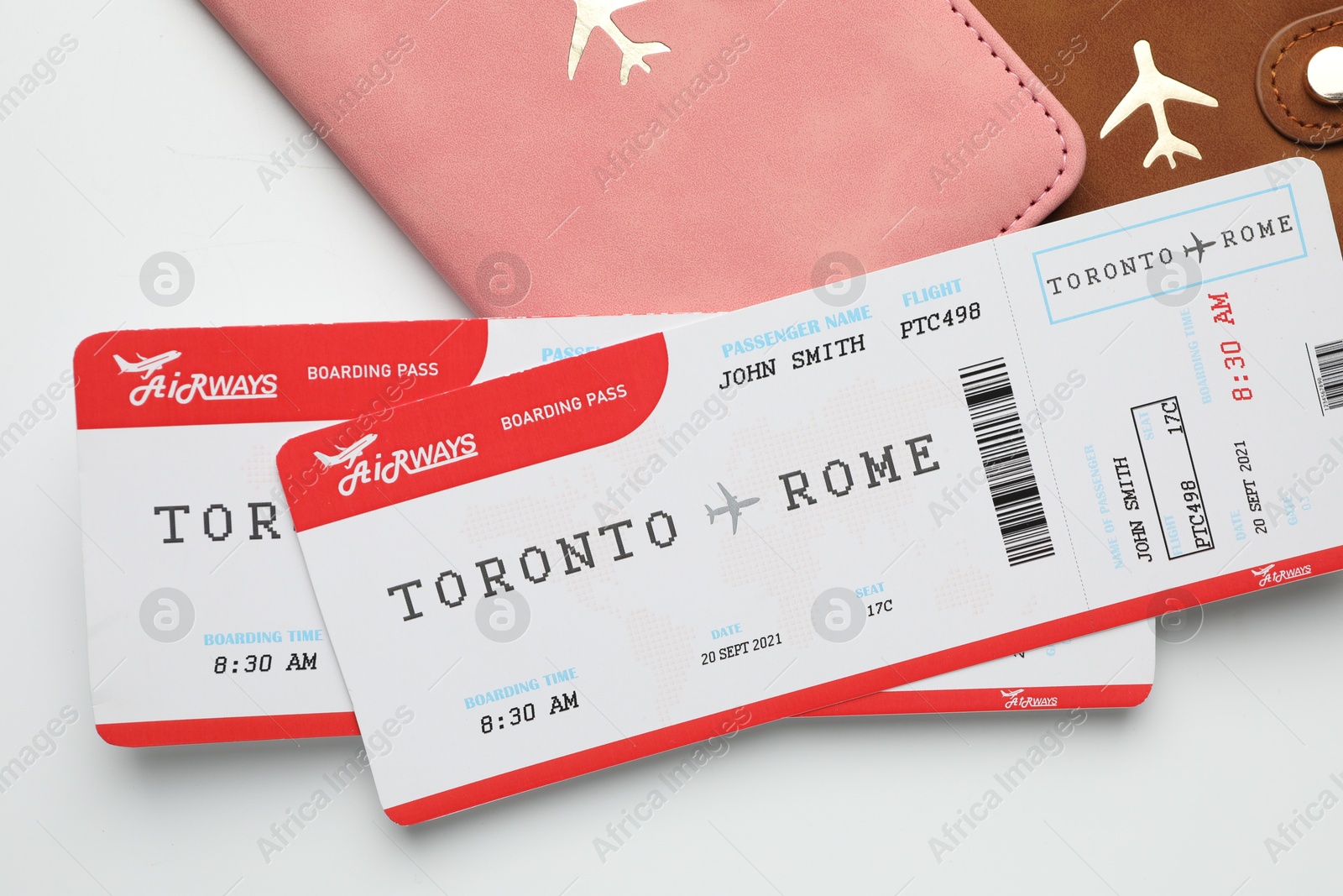 Photo of Travel agency. Flight tickets and passports on light background, flat lay