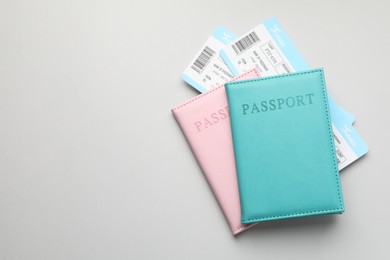 Photo of Travel agency. Flight tickets and passports on grey background, top view. Space for text