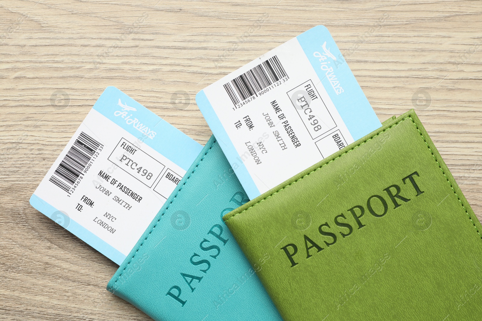 Photo of Travel agency. Flight tickets and passports on wooden table, top view