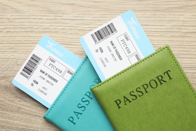 Photo of Travel agency. Flight tickets and passports on wooden table, top view