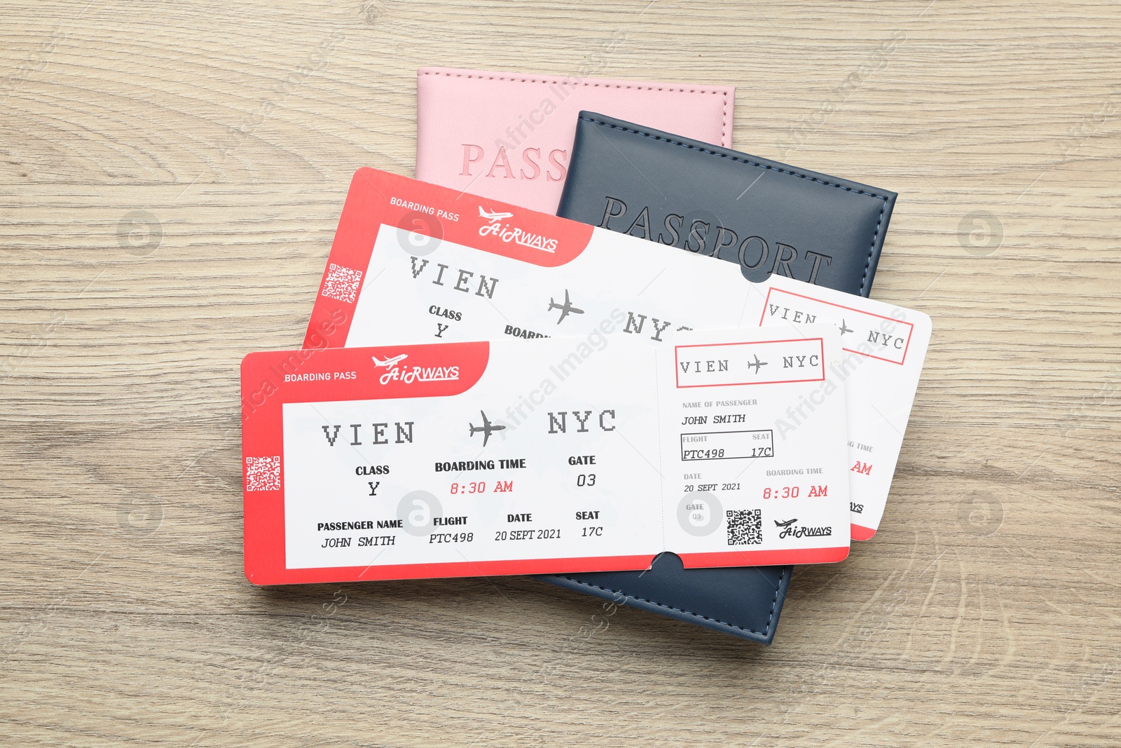 Photo of Travel agency. Flight tickets and passports on wooden table, top view