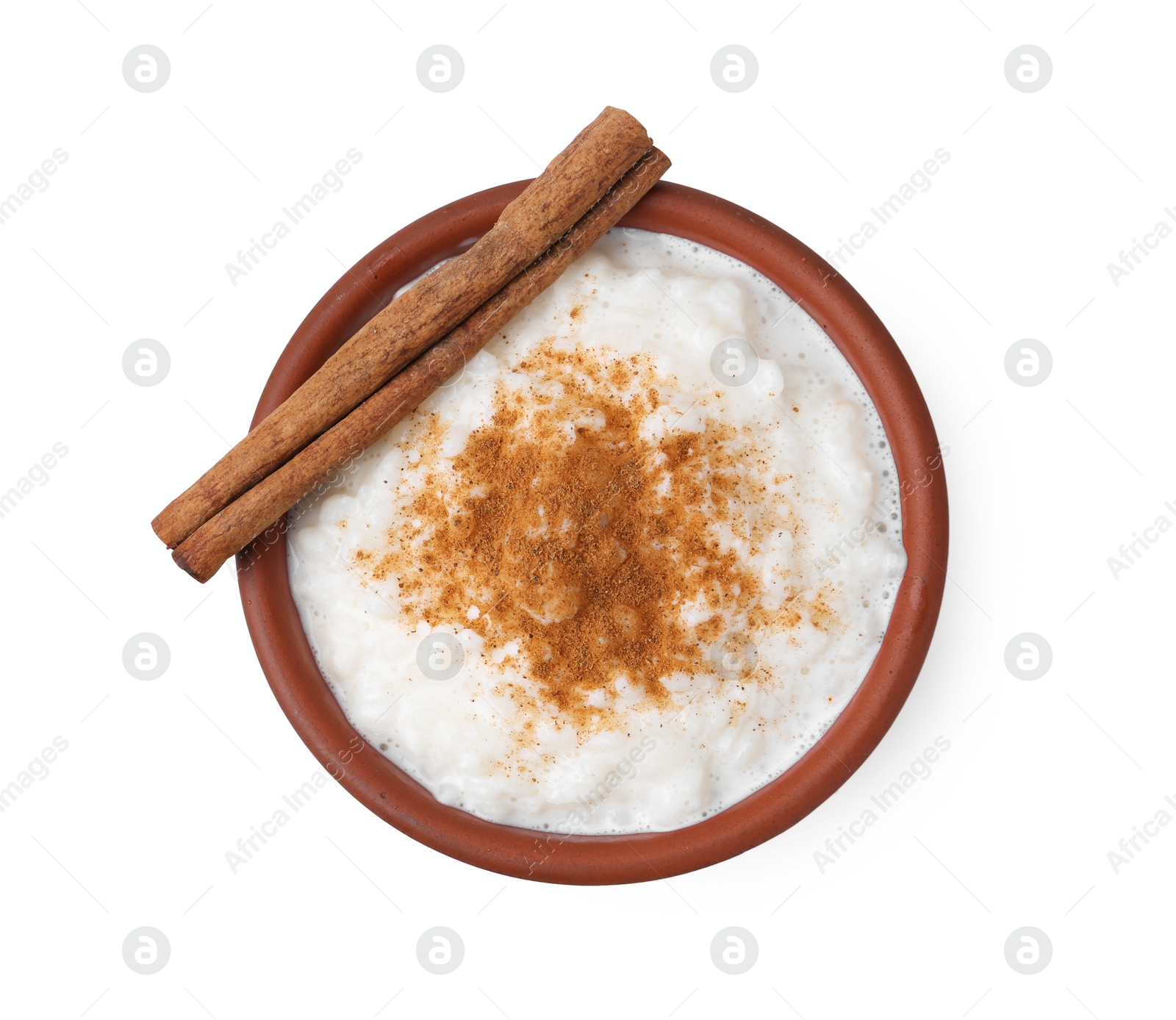 Photo of Delicious rice pudding with cinnamon isolated on white, top view