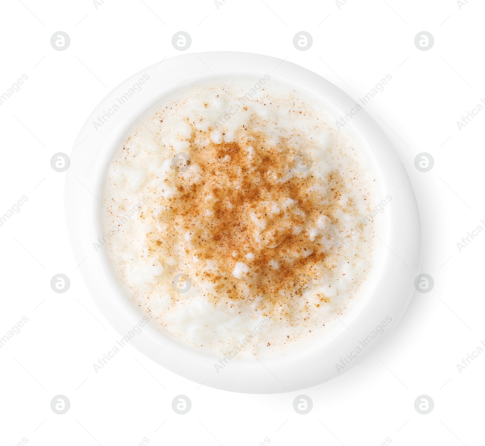 Photo of Delicious rice pudding with cinnamon isolated on white, top view