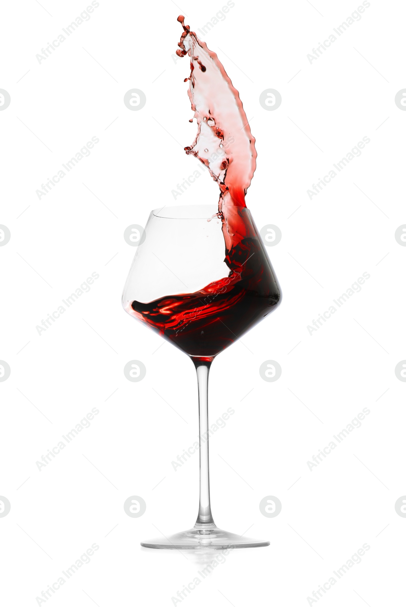 Photo of Red wine splashing in glass on white background