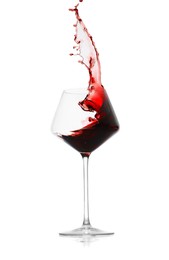 Photo of Red wine splashing in glass on white background