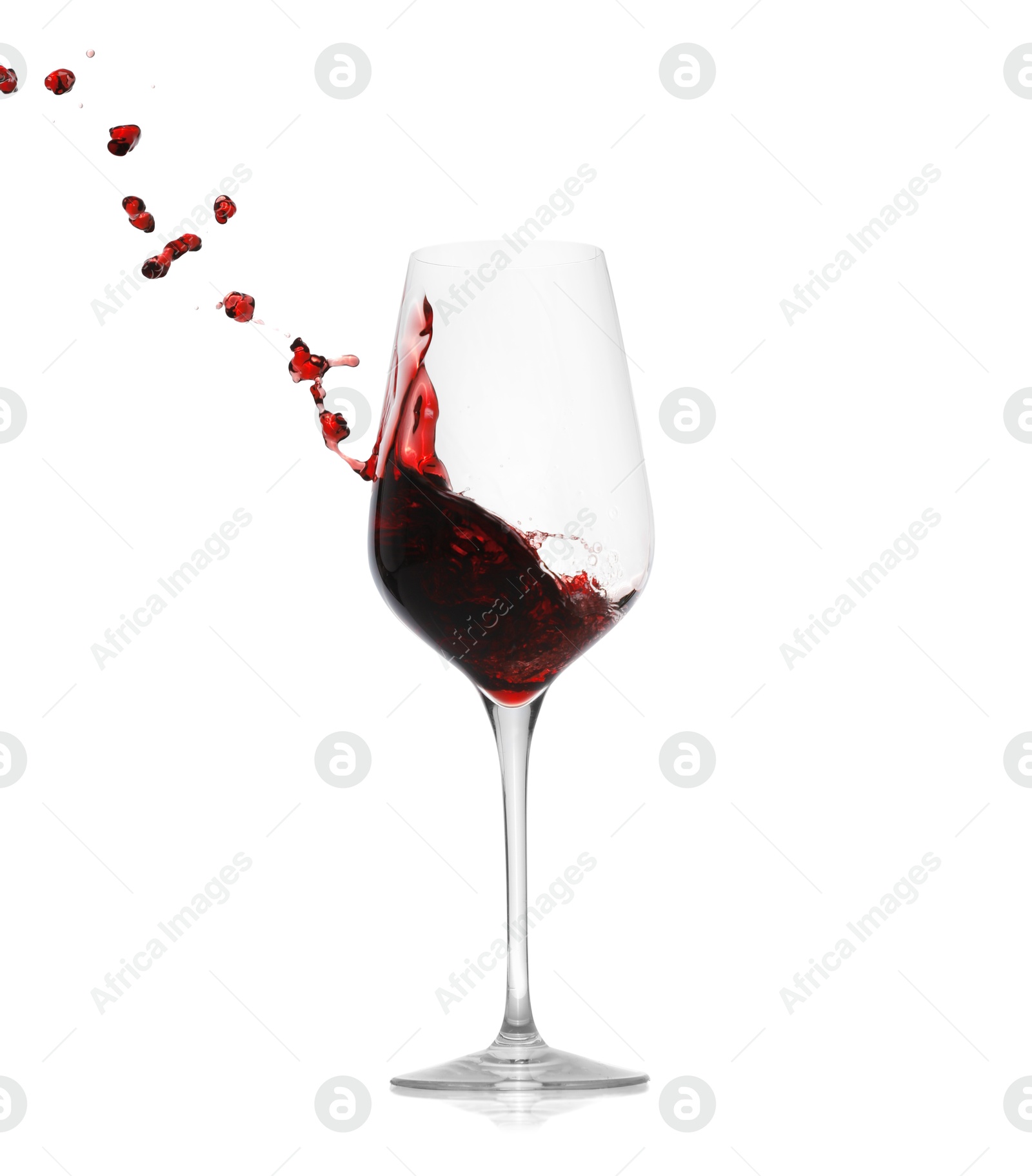 Photo of Red wine splashing in glass on white background