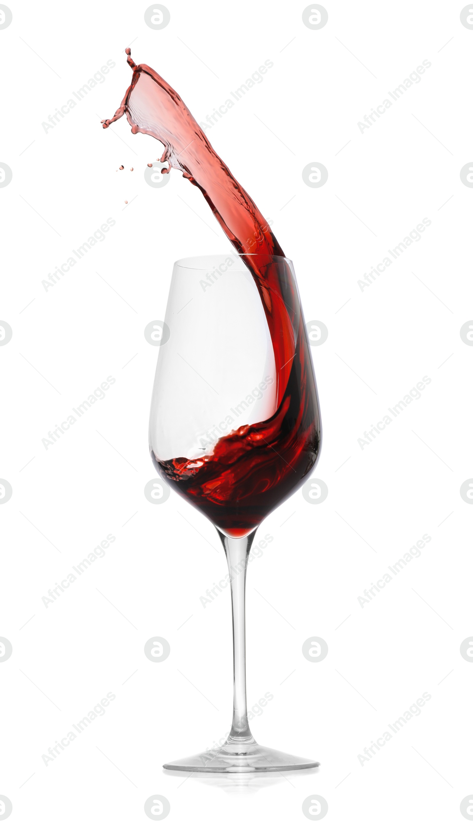 Photo of Red wine splashing in glass on white background