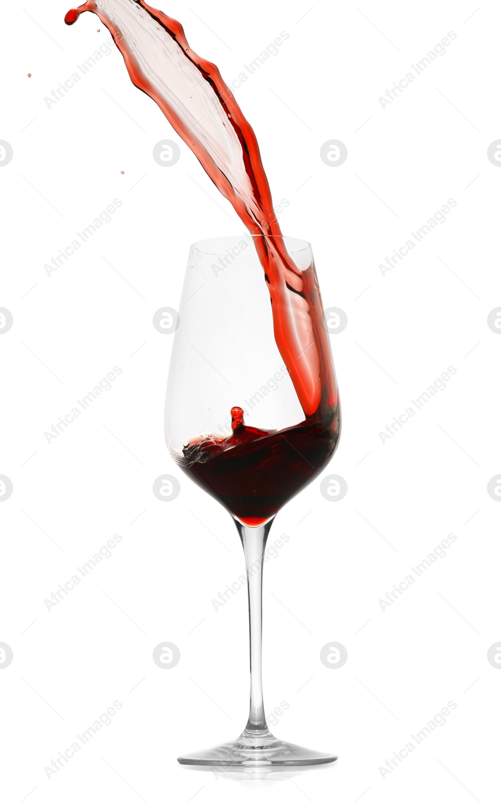 Photo of Red wine splashing in glass on white background