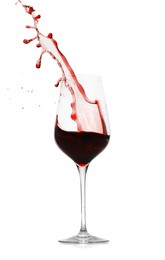 Photo of Red wine splashing in glass on white background