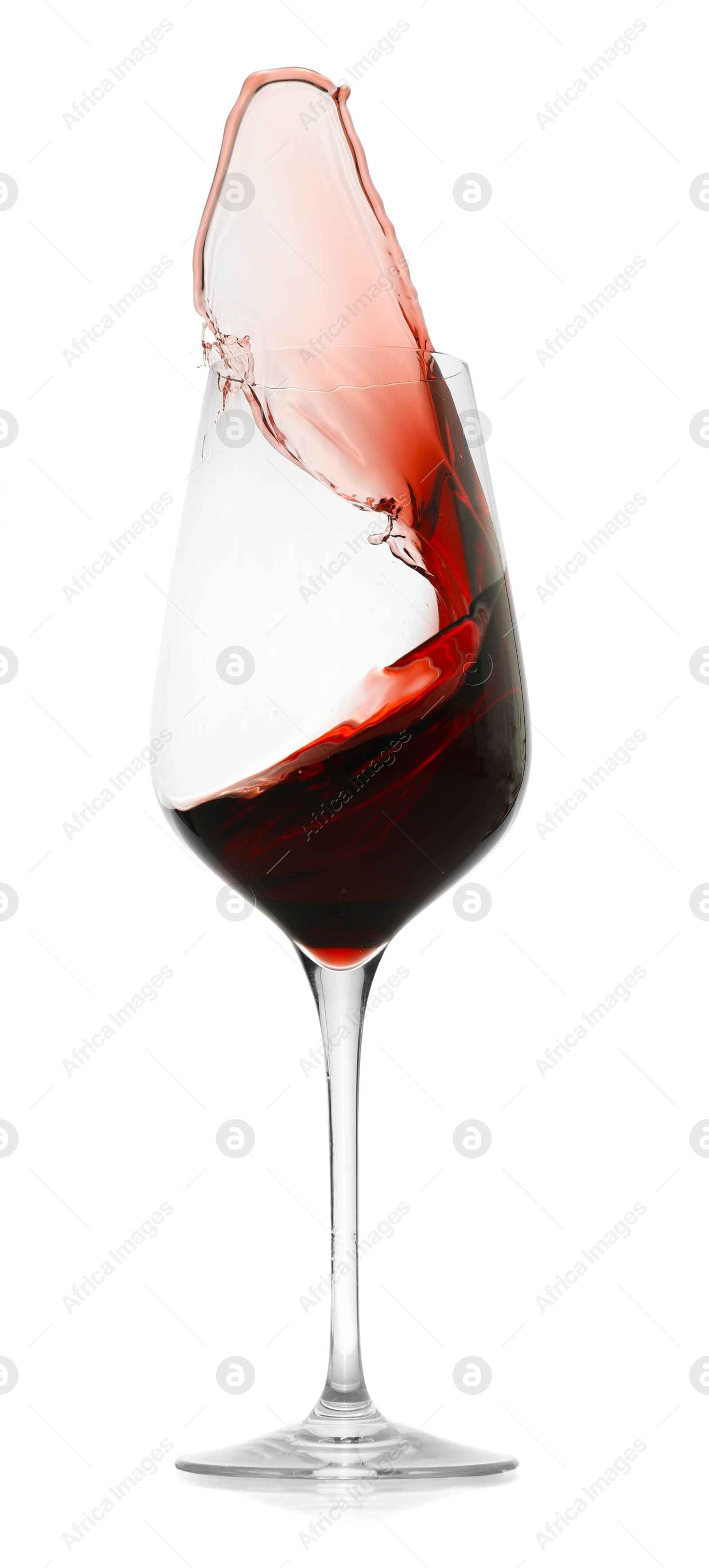 Photo of Red wine splashing in glass on white background