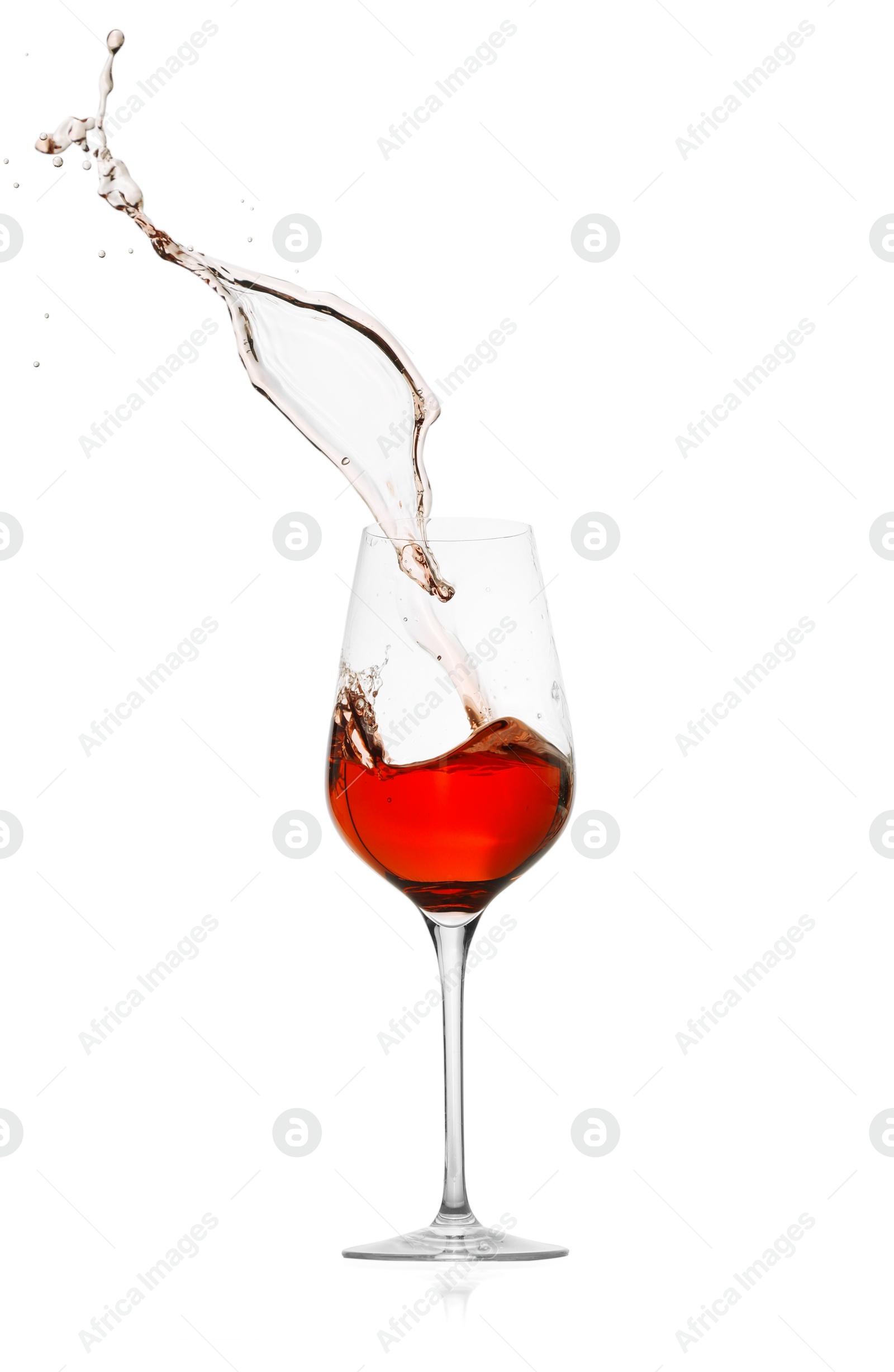 Photo of Rose wine splashing in glass on white background