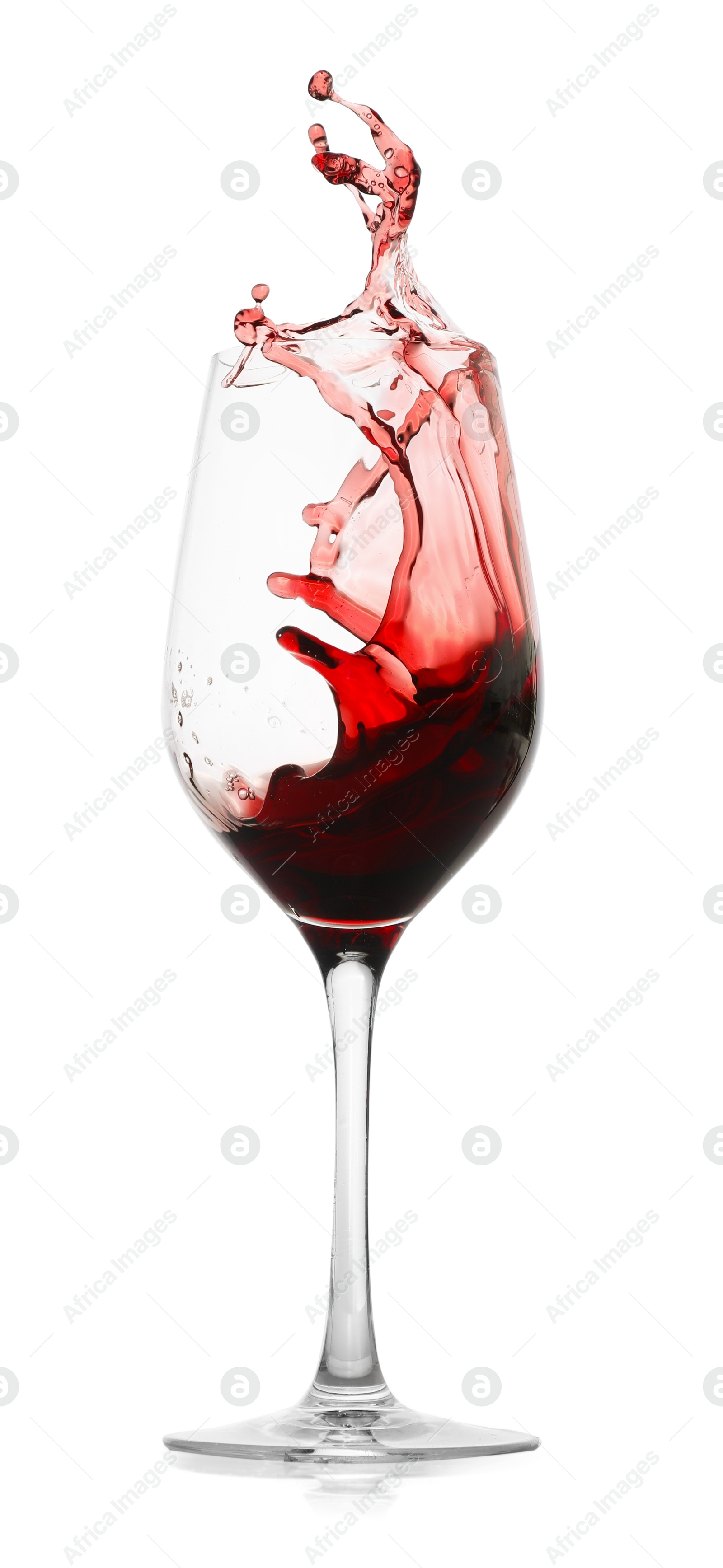 Photo of Red wine splashing in glass on white background