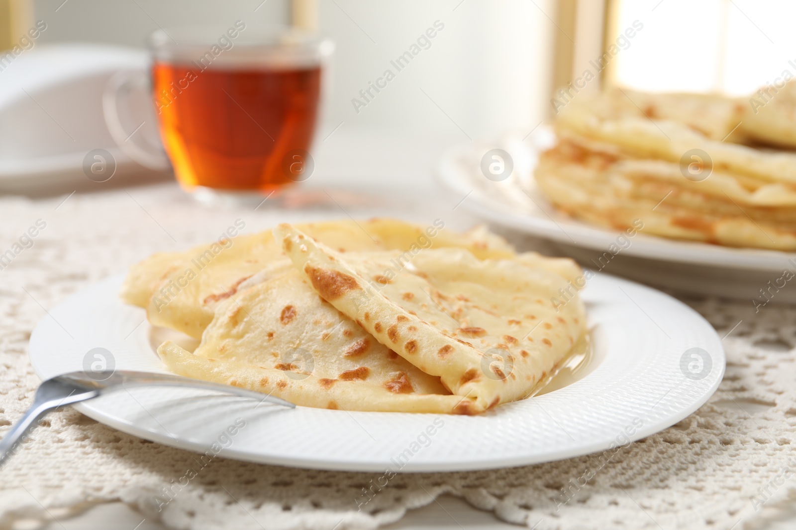 Photo of Tasty crepes served on table, closeup view