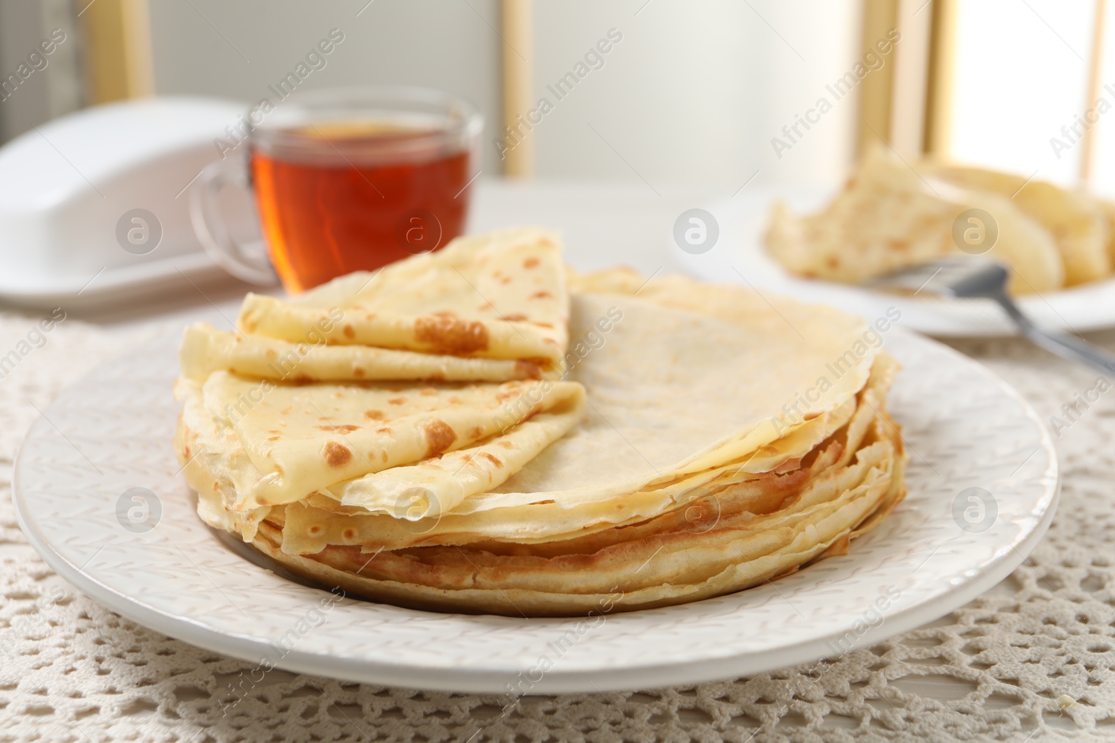 Photo of Tasty crepes served on table, closeup view