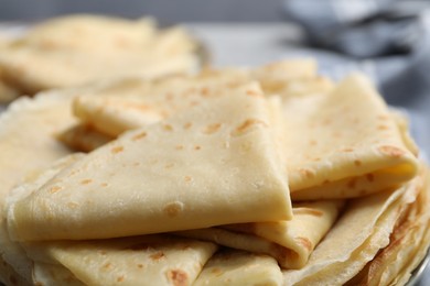 Photo of Tasty crepes on blurred background, closeup view