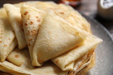 Photo of Tasty thin crepes on table, closeup view