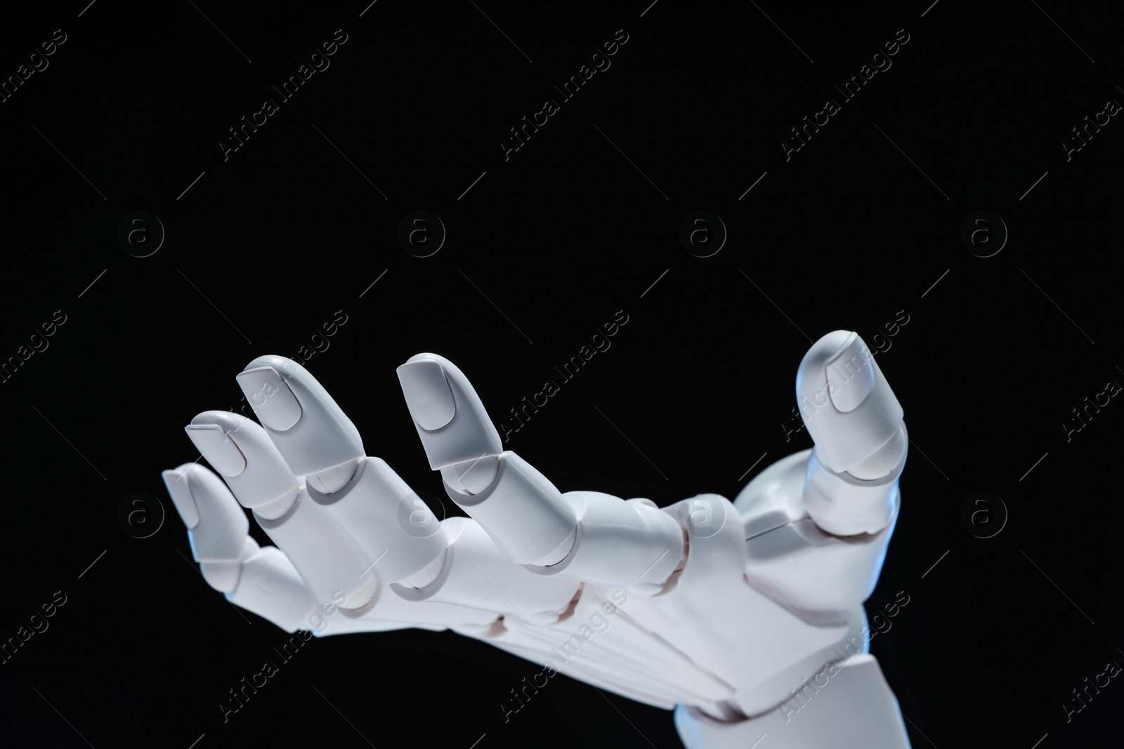 Photo of Artificial intelligence. Robot hand gesturing on black background