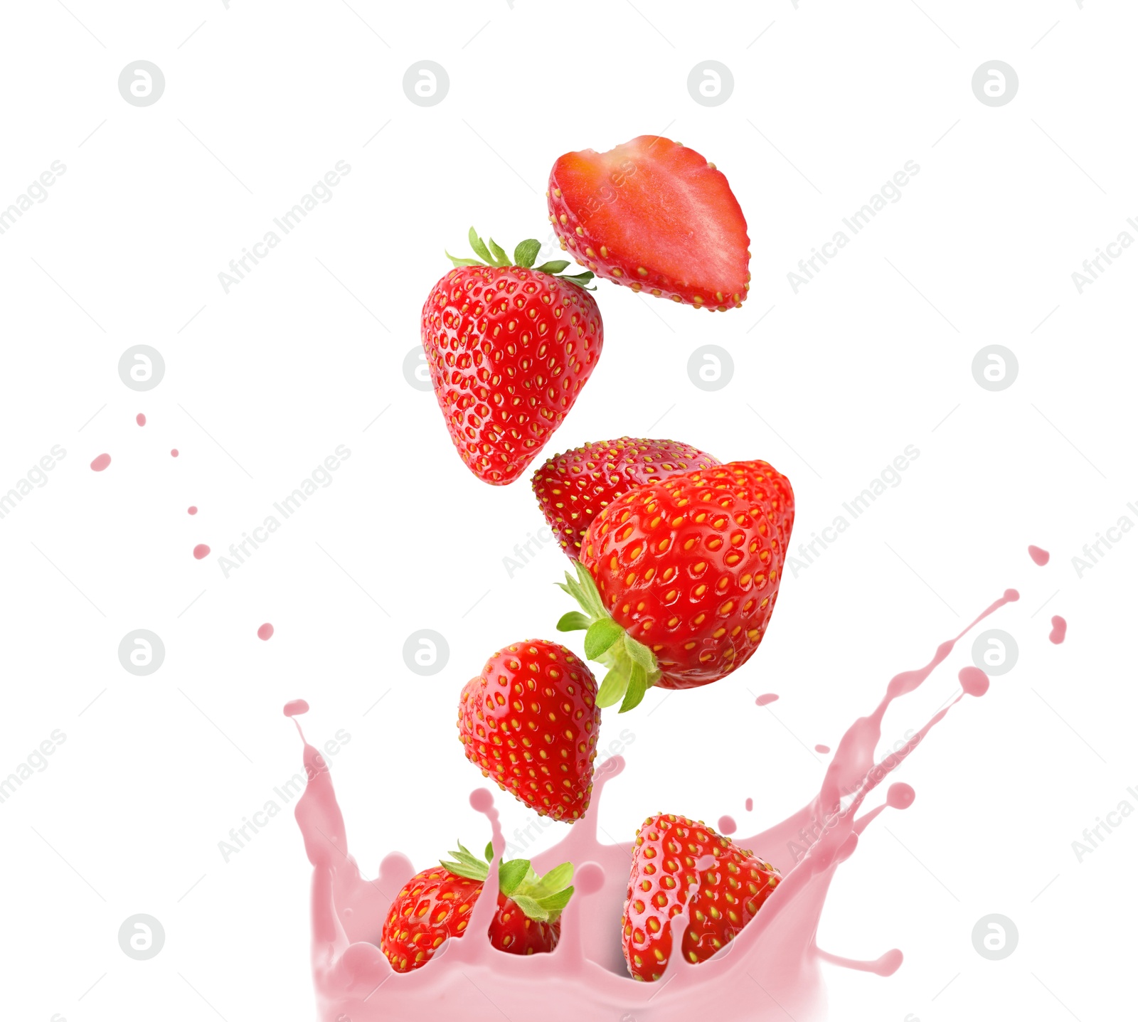 Image of Strawberries falling into tasty milkshake on white background