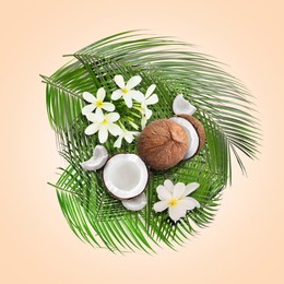 Image of Coconuts, tropical flowers and leaves on beige background