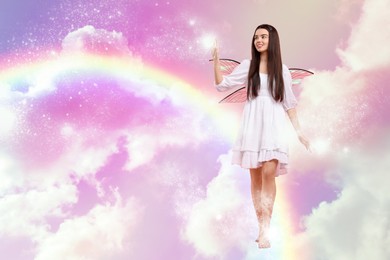 Ethereal fairy casting magic lights while walking among fluffy clouds in colorful sky. Beautiful girl with wings near rainbow