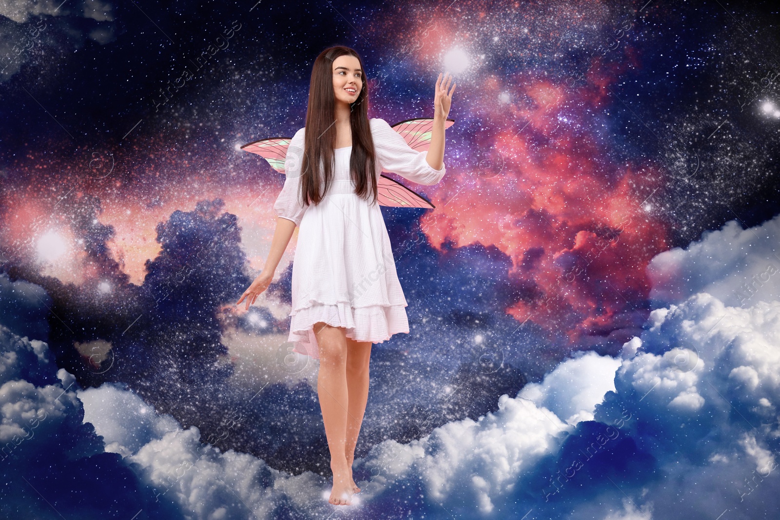 Image of Enchanting fairy casting lights while walking among fluffy clouds in dark sky. Beautiful girl with wings