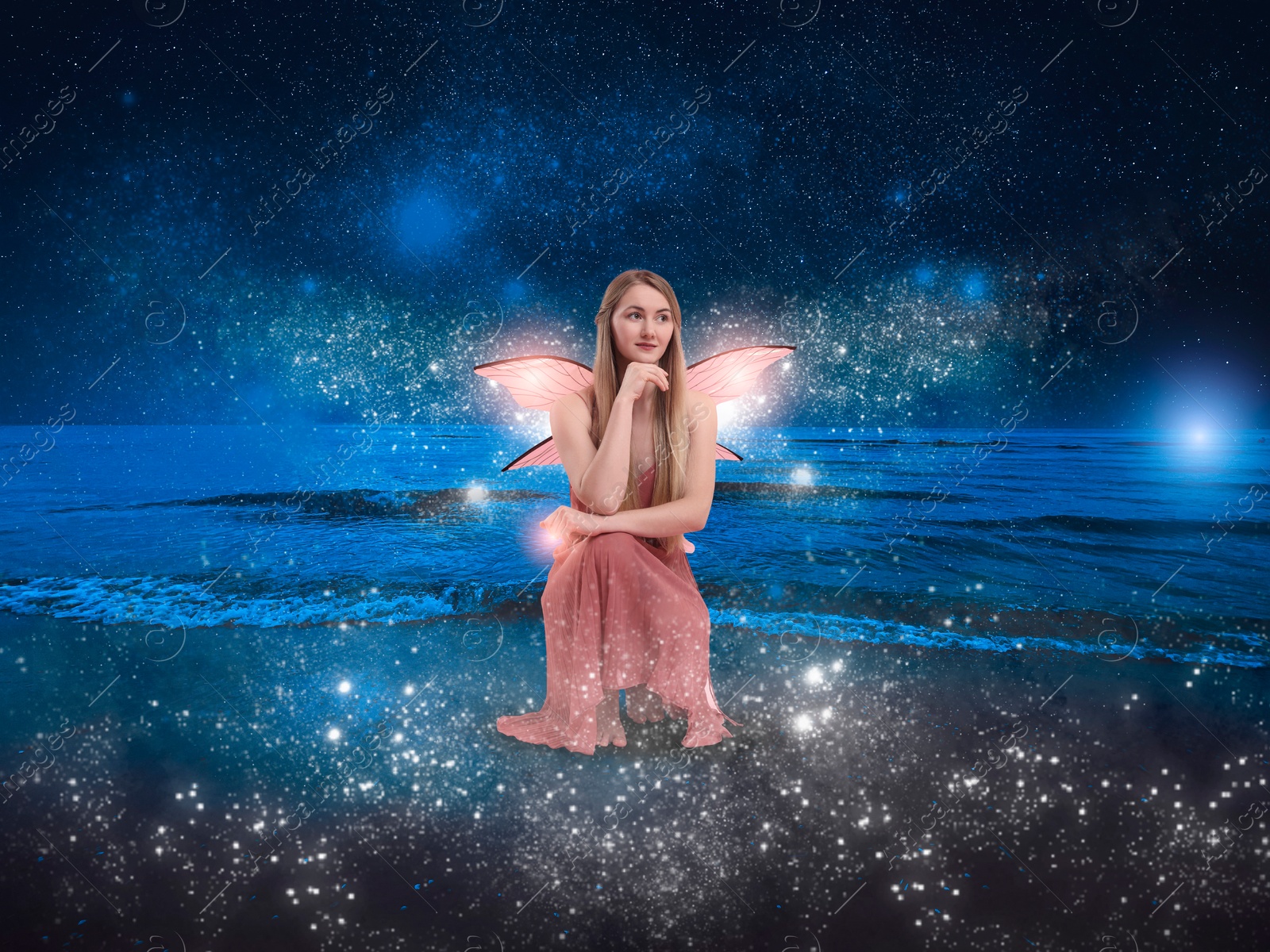 Image of Enchanting fairy among magic lights on seashore. Beautiful girl with wings