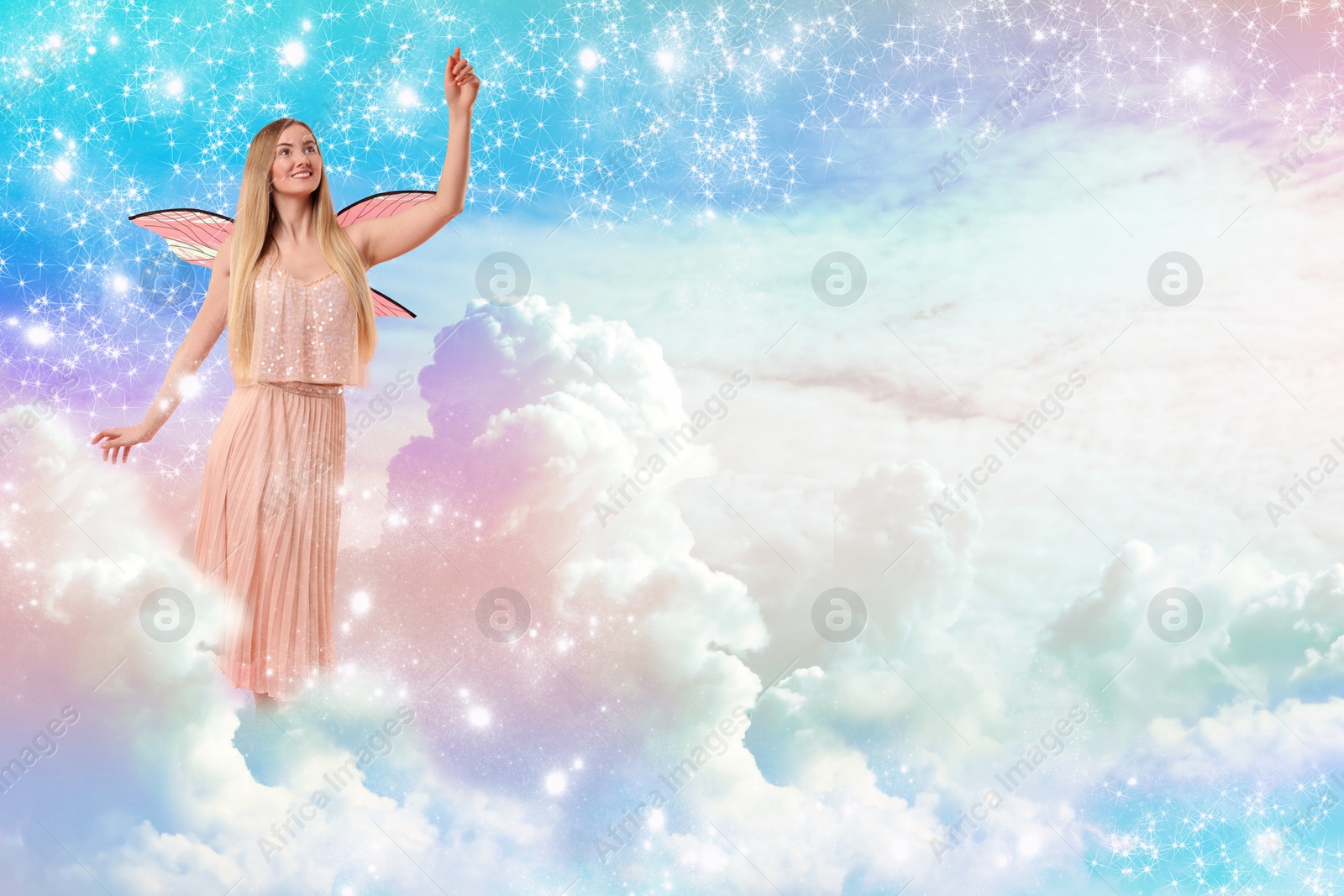 Image of Ethereal fairy among fluffy clouds in colorful sky. Beautiful girl with wings