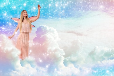 Image of Ethereal fairy among fluffy clouds in colorful sky. Beautiful girl with wings