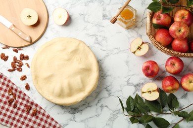 Photo of Flat lay composition with raw homemade apple pie and ingredients on white marble table